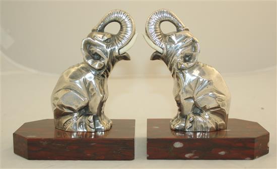 A pair of French Art Deco silvered metal and red marble elephant bookends, 5.5in.